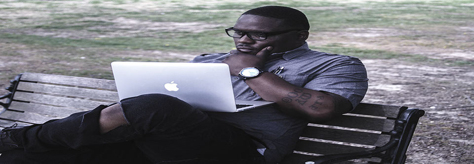 photo of the author The ghost sitting at park bench using his computer.